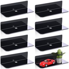 there are eight black shelves that have different cars on them and one has a potted plant in it