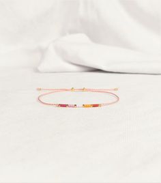 We offer a new Lesbian Flag Bracelet with the gold spacer and slider beads. The dainty and gentle piece that adds the colors of the Lesbian Pride in your look. The silver tone beads (spacers and sliders) are available too. DETAILS - The highest quality Japanese glass seed beads 2 mm - Strong nylon string, Light Salmon Pink by default or colorful by your request - The spacer and slider beads: Gold or Silver tone - Waterproof, but avoid perfume and lotions - This bracelet is lightweight and extremely comfortable to wear 24/7 - Comes in a small beautiful packaging. You can also update the standard packaging to the gift box when checkout. The shipping package is discreet. - The price is for one bracelet - Colors may vary slightly due to different monitor settings CLOSURE Two slider beads to ad Adjustable Rose Gold Beaded Friendship Bracelets, Dainty Adjustable Beaded Bracelets For Friendship, Pink Adjustable Friendship Jewelry, Gold Friendship Bracelets With Letter Beads, Adjustable Gold Beaded Bracelets As Best Friend Gift, Adjustable Gold Beaded Bracelets For Best Friend, Adjustable Pink Gold Beaded Bracelets, Rainbow Sliding Knot Bracelet As Gift, Adjustable Pink Gold Beaded Bracelet