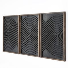 three panels with black and brown designs on the sides, one is made out of wood