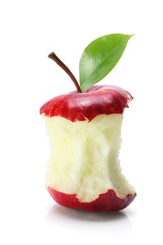 an apple cut in half with a green leaf sticking out of it's core