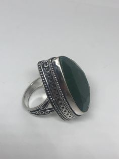 Vintage raw green emerald ring Lovely polished white bronze silver has the look of 925 set with a huge Green emerald Does not tarnish set in very detailed vintage filigree Size 7 We can size these with an additional $10-$20 fee for the jeweler All rings are shipped free in the US in a nice gift box. Check out our over a THOUSAND great reviews Engraving is $4 per letter and is not always perfect depending on the piece. It can take a few days if the jeweler is busy. This is payable to Paypal Judit Handmade Green Emerald Cut Ring, Handmade Green Emerald-cut Emerald Ring, May Birthstone Emerald Ring With Stone Setting, Bohemian Green Emerald Ring As A Gift, Bohemian Green Emerald Ring Gift, Unique Green Emerald Ring With Stone Setting, Green Emerald Ring With Stone Setting For Anniversary, Green Emerald Ring With Large Stone For Anniversary, Bohemian Green Emerald Gemstone Ring