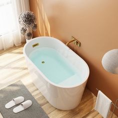 a bathroom with a bathtub and towel rack on the floor next to a window