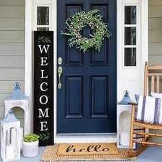 a front door with a welcome sign and rocking chair on the porch next to it