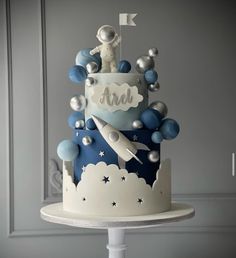 a blue and white cake with an astronaut on top