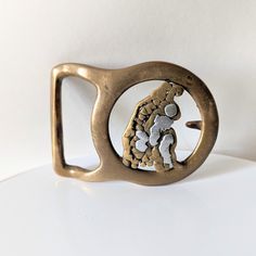 "This vintage 1970s belt buckle features a mixed metal design in the center of a brass frame. It measures about 3.25\" long. The belt loop would accommodate a belt that is 1.75\" wide. I don't see a maker's mark on this unusual buckle, but it is well-made and sturdy. This piece has some patina to the brass that could be polished if desired. It still looks great and has a cool artsy vibe.  Non-smoking environment. Thank you for visiting Feralia Vintage! Take a look around the shop: https://www.et Artsy Vibe, Napa Ca, Suspender Belt, Maker's Mark, Brass Frame, Metal Design, Mixed Metals, Vintage 1970s, Belt Buckle