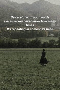 a woman walking across a lush green field with a quote on the side that reads, be careful with your words because you never know how many times it's repeating