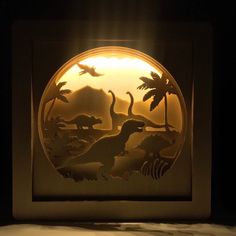 a light that is inside of a box with some dinosaurs in the middle of it