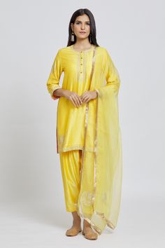 Yellow kurta with gota and aari work and buttoned placket. Paired with an embroidered pant and dupatta.
Components: 3
Pattern: Embroidered
Type Of Work: Gota, Aari
Neckline: Round
Sleeve Type: Three-quarter
Fabric: Kurta and Pant: Silk Chanderi, Dupatta: Organza
Color: Yellow
Other Details: 
Long
Occasion: Puja - Aza Fashions Diwali Traditional Cotton Silk Wear With Gota Work, Diwali Traditional Wear With Gota Work In Cotton Silk, Diwali Traditional Wear In Cotton Silk With Gota Work, Traditional Slub Silk Kurta With Sheer Dupatta, Transitional Cotton Silk Traditional Wear With Gota Work, Tissue Silk Traditional Wear Straight Kurta For Navratri, Yellow Slub Silk Kurta With Sheer Dupatta, Navratri Tissue Silk Kurta With Gota Work, Straight Kurta In Tissue Silk With Pallu