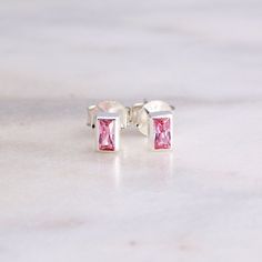 These maybe but small, but they are beautiful. Sometimes the best things come in small packages, like these light rose pink baguette CZ stud earrings. Perfect for everyday wear and made with high quality 925 sterling silver. Great for both ladies and girls alike! Size of setting is 4.6mm x 3mm. Comes with a wingback earnut push closure. Stamped with 925 on the post and wingback. Light Pink CZ is beautifully faceted and bezel set in this rectangle setting. Shipped in a beautiful deep plum colored jewelry box with our LUMIN TERRA logo in silver on the inside. Finished with a bow and ready for gifting. We Give Back: 5% of all proceeds are donated to Floating Hospital for Children in Boston, Massachusetts. Upper Ear Piercing, Boston Childrens Hospital, Colored Jewelry, Deep Plum, Light Rose, Cz Stud Earrings, Earrings Dainty, Crystal Stud Earrings, Boston Massachusetts