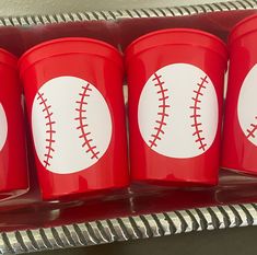 three red cups with baseballs painted on them