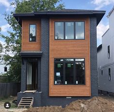 a house is being built in the middle of a construction area with some dirt on the ground