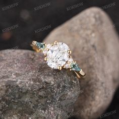 a close up view of a diamond ring on top of a rock