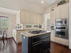 a large kitchen with an island in the middle