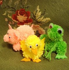 three stuffed animals sitting next to each other on a green couch with flowers in the background