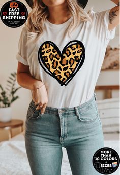 Leopard Heart shirt, Leopard Print Valentines Day Shirt, Trendy Leopard T-shirt, Cute Valentine Shirt, Valentines Day Gift, Mother's Day tee How - To - Order - Select Your Shirt Style  - Select Your Shirt Color - Select Your Design (Personalization Box) If Applicable - Select Your Quantity - Add Item to Your Cart -- If You Will have more than one shirt you can add them to your cart one by one so you can have one order. -- If Shown picture was 2 shirt you must add both to the cart. Production & Shipping - After you order we will process your order in 1-3 business days. - After we ship your order shipping time is base on your shipping choosing  - If you need to RUSH your order you can contact directly with messages to me and I will show you our rush options. -Designs on computer screen can l Cute Shirt With Heart Graphic And Crew Neck, Cute Crew Neck Shirt With Heart Graphic, Fun White Top With Heart Graphic, White T-shirt With Heart Print For Mother's Day, Trendy Tops With Heart Graphic For Gift, Trendy Heart Graphic T-shirt As Gift, White Heart Print T-shirt For Mother's Day, Mint Shirt, Peach Shirt