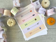 several rolls of paper sitting on top of each other next to pumpkins and squash