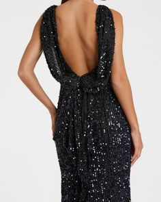 the back of a woman wearing a black sequin dress