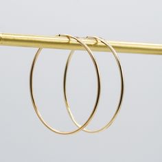 A Bold-But-Subtle Design: The 14k Gold Filled 40mm Endless Hoop Pair. This classic and trendy hoop will be your daily go to. The thickness of the 14k gold filled is 1mm and the diameter of the hoops is approximately 1.5". Lightweight for all day wear. All Jewel Ya hoops are designed to fit over 100 gemstone, pearl and fine metal drops. Change your earrings daily by adding a new set of hoop drops. Every Jewel Ya design arrives in our signature acrylic container for airtight storage. Elegant 14k Gold Filled Circle Hoop Earrings, 14k Gold-filled Tarnish-resistant Hoop Earrings, 14k Gold Filled Tarnish Resistant Hoop Earrings, Tarnish Resistant 14k Gold Filled Hoop Earrings, Elegant 14k Gold Filled Hoop Earrings, 14k Yellow Gold Filled Hoop Earrings, Hypoallergenic 14k Gold Hoop Earrings, Dainty Yellow Gold Hoop Earrings, Adjustable 14k Yellow Gold Filled Hoop Earrings