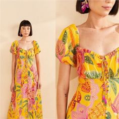 A Bright Shade Of Yellow As Flattering As The Sunlight Of A Summer Afternoon. The Yellow Macaw Bloom Midi Dress Is Here Then You Can Step Into Your Fave Season In The Most Effortless Way Possible. It Features A Contemporary Twist On A Classic Silhouette With A Cute Neckline With Beaded Tassels, Front Buttons, And A Tropical Print Designed For Those Forever In Love With The Sun And Ready To Shine In Every Place.Questions? Leave A Comment Below! 100% Viscose Length: 47.5' Pit Tp Pit : 13" Vibrant Yellow Vacation Dress, Yellow Bohemian Midi Dress With Short Sleeves, Yellow Short Sleeve Maxi Dress For Garden Party, Yellow Short Sleeve Midi Dress Bohemian Style, Yellow Tropical V-neck Dress, Yellow V-neck Dress With Tropical Print, Yellow V-neck Tropical Dress, Yellow Bohemian Midi Dress For Brunch, Yellow Tropical Dress For Brunch