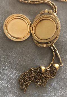 "Vintage A-C 12K Gold-filled Locket Tassel Lariat Pendant Necklace. Size: Necklace- 29\"x 3/16\"(3mm). Locket: 1\"x1 1/4\" round. Markings: A-C 1/20 12KT GF. Beautiful. Sold as is. Pre-Owned." Elegant Medallion Locket Necklace With Adjustable Chain, Elegant Locket Necklace With Adjustable Chain, Bohemian Lariat Jewelry For Formal Occasions, Gold Tassel Jewelry For Evening, Luxury Formal Tassel Jewelry, Vintage Lariat Necklace With Adjustable Chain For Gifts, Vintage Yellow Gold Jewelry With Detachable Pendant, Vintage Adjustable Lariat Necklace As Gift, Vintage Engraved Lariat Jewelry