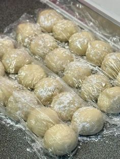 doughnuts are wrapped in plastic and ready to be baked on the counter top