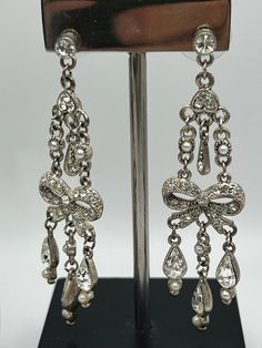 "Vintage elegant chandelier shape  earrings.Silver  tone metal clear glass crystals seeded pearls  Not singed Measures 2 3/4\"x 3/4\" In very good vintage condition. Please keep mind each electronic device has different resolution, brightness and clarity. Therefore products might have slight difference of shade/tone/color in person. Please see my other listings and thanks for shopping." Cheap Vintage Silver Chandelier Earrings, Silver Pearl Drop Clip-on Earrings For Evening, Silver Rhinestone Drop Clip-on Earrings, Sparkling Silver Clip-on Earrings For Evening, Silver Sparkling Clip-on Earrings For Wedding, Formal Ornate Dangle Chandelier Earrings, Ornate Dangle Bridal Earrings For Formal Occasions, Ornate Dangle Chandelier Earrings For Formal Occasion, Glamorous Silver Clip-on Earrings With Rhinestones