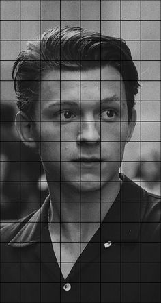 a black and white photo of a man in front of a grid pattern with his eyes wide open