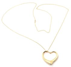 About This Piece: Metal: 18k Yellow Gold Pendant Size: 36mm x 33mm Weight: 15.1 grams Length Chain: 30" Hallmarks: Heart: Tiffany & Co. 18k PerettiChain: Tiffany & Co. 750 Peretti T2801merd Open Heart Necklace, Vintage Designer Jewelry, Elsa Peretti, Cute Necklace, Yellow Gold Pendants, Open Heart, Earring Necklace, Tiffany & Co., Ring Necklace