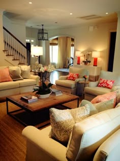 a living room filled with lots of furniture and pillows on top of it's couches