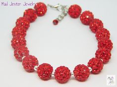 Perfect for a party or simply to add sparkle to your outfit!  Red disco ball beads are covered in rhinestones to shine and shimmer.  Bracelet is 8 inches long with a 0.5-inch extender chain, accented with a tiny red bead, to adjust the length.   All of my jewelry is carefully hand-crafted at the time that you order, so please allow an extra day or so for the creation of your bracelet before I ship to you. * Matching sparkly earrings can be found here:  https://www.etsy.com/listing/1381856353 * Thank you for shopping with Mad Jester Jewelry! Red Disco Ball, Sparkly Bracelets, Outfit Red, Woven Chain, Sparkly Earrings, Red Bead, Disco Ball, Adjustable Bracelet, Bead Bracelet