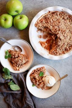 two plates filled with dessert next to green apples