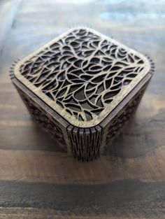 an intricate wooden box sitting on top of a table