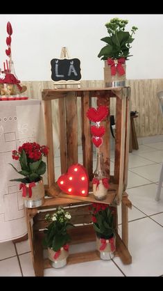 some potted plants are sitting on a chair with lights in the shape of hearts