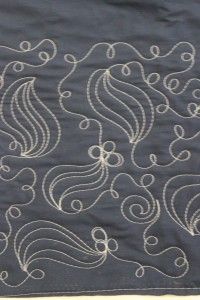 a black and white quilt with swirls on it