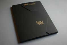 two black folders with gold lettering on them