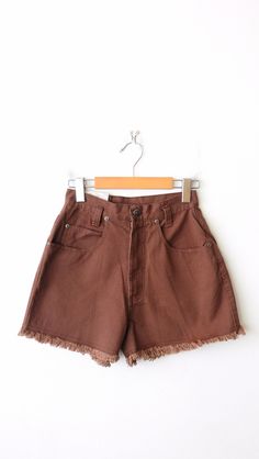 "Unworn-Vintage Brown High Waisted Cut off Jean Shorts. Measurements Total Length    : 12 1/2\" Waist                : 23\" Hips                  : 36\" Rise                  :  11 1/2\" Inseam             :  2\" Condition        : Never been worn. There' white stitches as shown in the last pic.  ※Please read the policy before you purchase※" Retro Short Bottoms With Frayed Hem, 90s High-waisted Cotton Shorts, 90s Style High-waisted Cotton Shorts, Brown Bottoms With Frayed Hem For Spring, Vintage High Rise Bottoms With Pockets, Retro Cotton Shorts With Frayed Hem, Vintage Short Bottoms With Belt Loops, Vintage Cotton Shorts With Frayed Hem, Retro Brown Cotton Bottoms