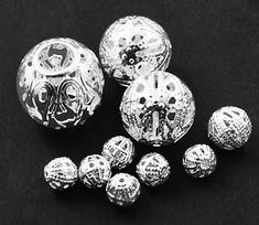 several silver balls on a black surface