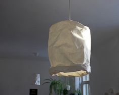 a white paper bag hanging from a ceiling