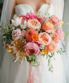 a bride holding a bouquet of flowers in her hands