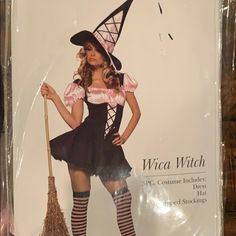 a woman in a witch costume holding a broom