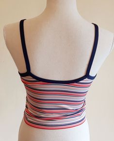 Sweet vintage Champion sports crop top. Colorful stripes,blue suspenders and a edge around the sleeve. It has a logo printed at the end. Fabric is stretchy. It is padded on the chest,see last image. In excellent vintage condition. Tag size: US M,but smaller,best fits to size US XS/S,check the measures. Materials: polyester 88%,spandex 12% Label: Champion  Measures taken flat,one side bust 36.5 - 48 cm = 14,37 - 18,90" waist 34 - 37 cm = 13,38 - 14,57" length with suspenders about 43 cm = 16,93" We will take returns only if there is a problem with condition we did not detected. Please,check the measures before purchasing. All items are vintage in excellent condition with respect to the years. Please write me a message when the package arrives and are you satisfied. Thank you for purchasing Fitted Blue Top With Contrast Stripes, Summer Sports Tops With Contrast Stripes, Summer Sports Top With Contrast Stripes, Spring Striped Sports Tops, Striped Fitted Tank Top With Tank Straps, Striped Fitted Crop Top Tank, Fitted Striped Crop Top Tank, Multicolor Fitted Tops With Adjustable Straps, Fitted Multicolor Tops With Adjustable Straps