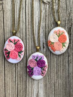 This is a hand embroidered floral pendant necklace made with utmost care and love. It makes for a perfect little gift for a loved one. This unique design is made with 100% cotton fabric and cotton embroidery floss. It is set in an antique bronze frame and comes with a chain length of your preference. Each chain also comes with extension margin of about 1.5 inches.  I offer free shipping within Canada. If you're located in KW region, Ontario I can arrange for a pick up. Orders are sent as standar Floral Embroidered Flower Jewelry For Weddings, Pink Embroidered Wedding Jewelry, Bohemian Jewelry With Floral Embroidery For Gifts, Pink Embroidered Jewelry As A Gift, Handmade Necklace For Bridesmaid Gift, Mother's Day, Handmade Necklace For Bridesmaid Gift On Mother's Day, Vintage Jewelry With Floral Embroidery For Gift, Embroidered Pendant Necklace For Gift, Hand Embroidered Pendant