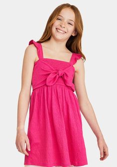 JustFab Pink female Fashion >> Kids >> Girls >> Clothing >> Dresses & Rompers regular Fit: Semi-fitted bodice. Length: Hits above the knee. Fabric: 65% Polyester, 32% Cotton, 3% Spandex. Machine wash cold. Imported. When in doubt, pink is always a good answer! This sweet dress has ruffles at the straps, comfy smocking around the whole bodice, and a faux-tie front for a super-cute look. Smocked Tie Front Dress Pink Dress With Ruffled Tie Straps, Pink Sundress With Square Neck And Tie Straps, Pink Square Neck Sundress With Tie Straps, Pink Square-neck Sundress With Tie Straps, Pink Dress With Bow And Ruffled Straps, Casual Sundress With Ruffled Straps And Tie Back, Casual Sundress With Tie Back And Ruffled Straps, Pink Dress With Tie Back And Ruffled Straps, Pink Smocked Dress With Square Neck And Smocked Back