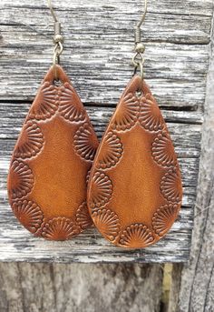 Shades of warm caramel are surrounded by an intricate Southwestern design that makes these earrings pop. Crafted from premium veg-tanned leather, these earrings are dyed by hand making them a truly unique, one-of-a-kind pair.  All leather earrings are conditioned with beeswax, which keeps the leather supple and water resistant (as seen in video). Edges and backs are finished, as well. Please remember that time and wear ages leather beautifully, transforming your pieces into truly personalized je Leather Diy Earrings, Concho Dangle Earrings For Gift, Hand Tooled Adjustable Dangle Earrings, Bohemian Brown Jewelry With Matching Earrings, Bohemian Hand-tooled Drop Earrings, Adjustable Concho Earrings For Festival, Handmade Southwestern Brown Jewelry, Hand Tooled Teardrop Bohemian Earrings, Brown Hand Tooled Dangle Earrings