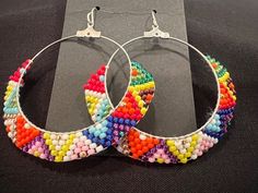 Very bright and colorful hand beaded hoop earrings. You can dress up or down with this pair. They are light weight so are easy to wear for an entire day.