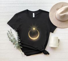 "Golden Moon And Sun Shirt, Mystical Sun And Moon Shirt, Crescent Sun Moon Shirt, Celestial Shirt Moon, Moon Sun Magical Shirt, Mystic Shirts ☀️☀️☀️☀️☀️ Everything in our shop is hand crafted and made to order. If you want different color or size contact me! If you would like something custom made to fit your personal style please message me and I will do everything to get you that something special. ---How To Order--- ⭐️Please, check and review all photos ⭐️Choose your t-shirt size and color ⭐️Enter your Design Color Example: \"White\" ⭐️Click add to cart. You can go back to add more product ⭐️Click \"Proceed to check out\" ⭐️When you check out, you can add a note to seller for any request *High quality and super soft, comfortable shirt. Made with top of the line vinyl and pressed with a Cheap Moon Print Short Sleeve T-shirt, Cheap Trendy Tops With Moon Print, Mystical Moon Shirt, Cresent Moon Shirt, Spiritual Sun, Sun And Moon Shirt, Celestial Shirt, Moon Top, Golden Moon