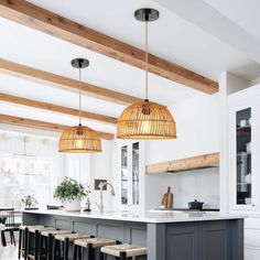 a kitchen with wooden beams and hanging lights