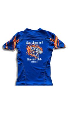 the back of a blue shirt with flames on it and an image of a dragon