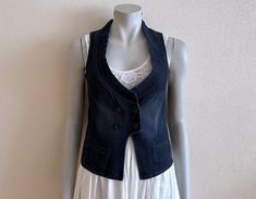 Women's Vest Blue Denim Vest Blue Jean Waistcoat Fitted Womens Sleeveless Denim Jacket  Measurements (lying flat): Length(back): 19.5"/ 49.5 cm Pit to pit: 15 3/4"/ 40 cm Waist: 15 1/4"/ 39 cm Please check measurements to insure a proper fit. Remember to allow yourself some extra room for movement. You can compare these with something from your closet that fits you well. Please convo me if you need additional measurements. Condition: Great Vintage Condition N.B. Color may slightly differ from pi Dark Wash Denim Vest For Workwear, Spring, Dark Wash Denim Vest For Workwear In Spring, Sleeveless Medium Wash Denim Vest For Workwear, Stretch Denim Blue Vest For Spring, Sleeveless Denim Vest For Work Medium Wash, Sleeveless Medium Wash Denim Vest For Casual Work, Denim Blue Sleeveless Workwear Vest, Stretch Denim Blue Sleeveless Vest, Sleeveless Denim Jacket For Summer Workwear