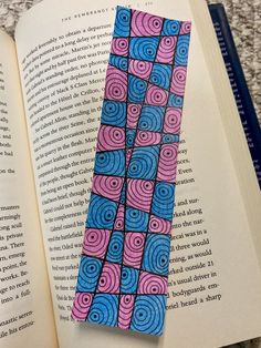 an open book with a blue and pink pattern on it